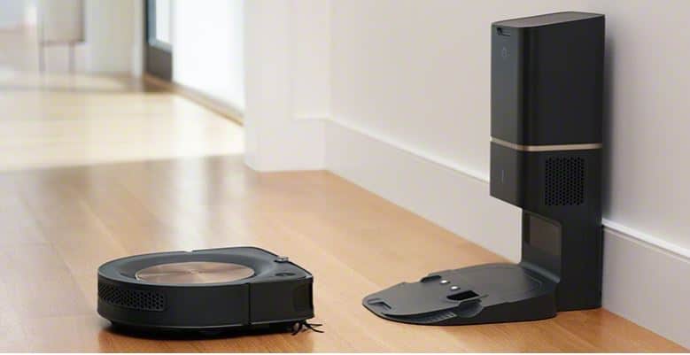 The vacuum cleaner sits in front of cleaning base station. Image via iRobot