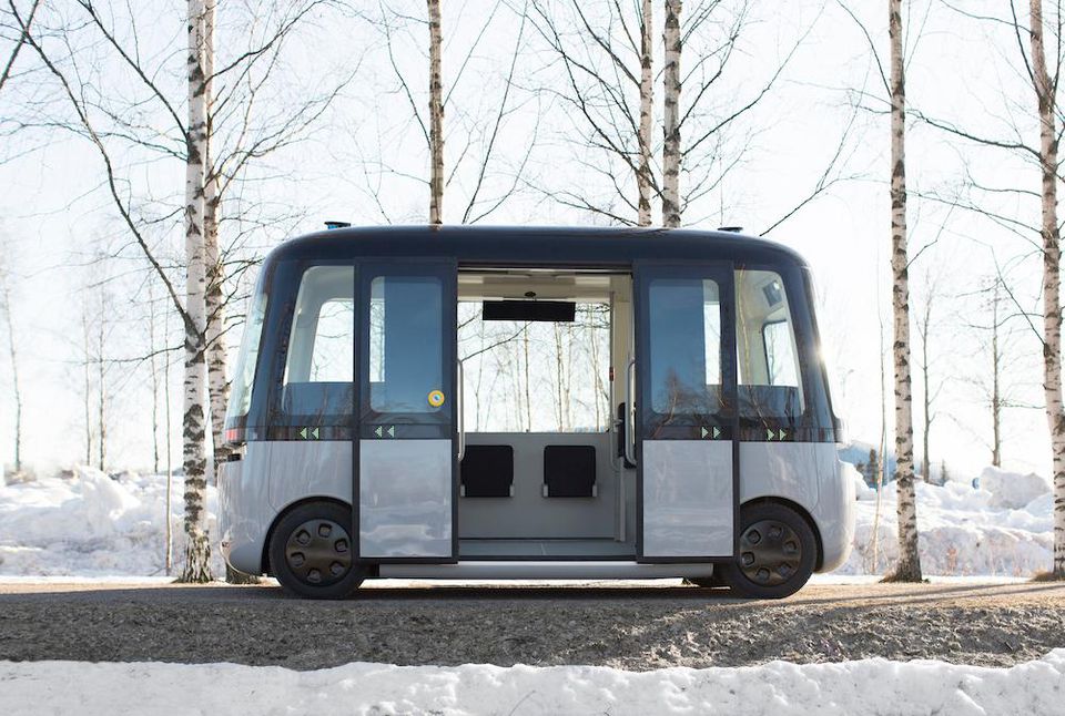 The autonomous bus sits on a snowy pathway. Image via Muji
