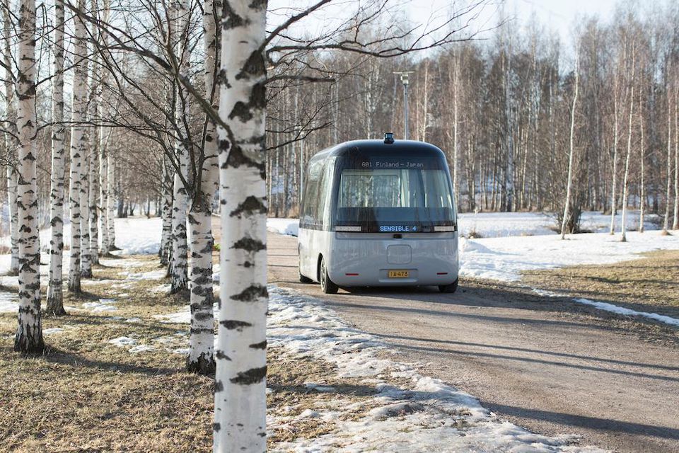 The shuttle bus tracks through the snowy forest of Finland. Image via Muji